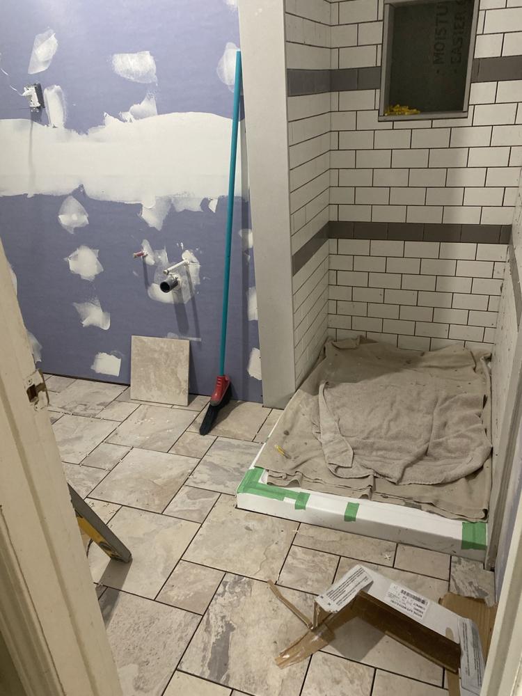 Hilltop basement bathroom during wall, tile and floor work