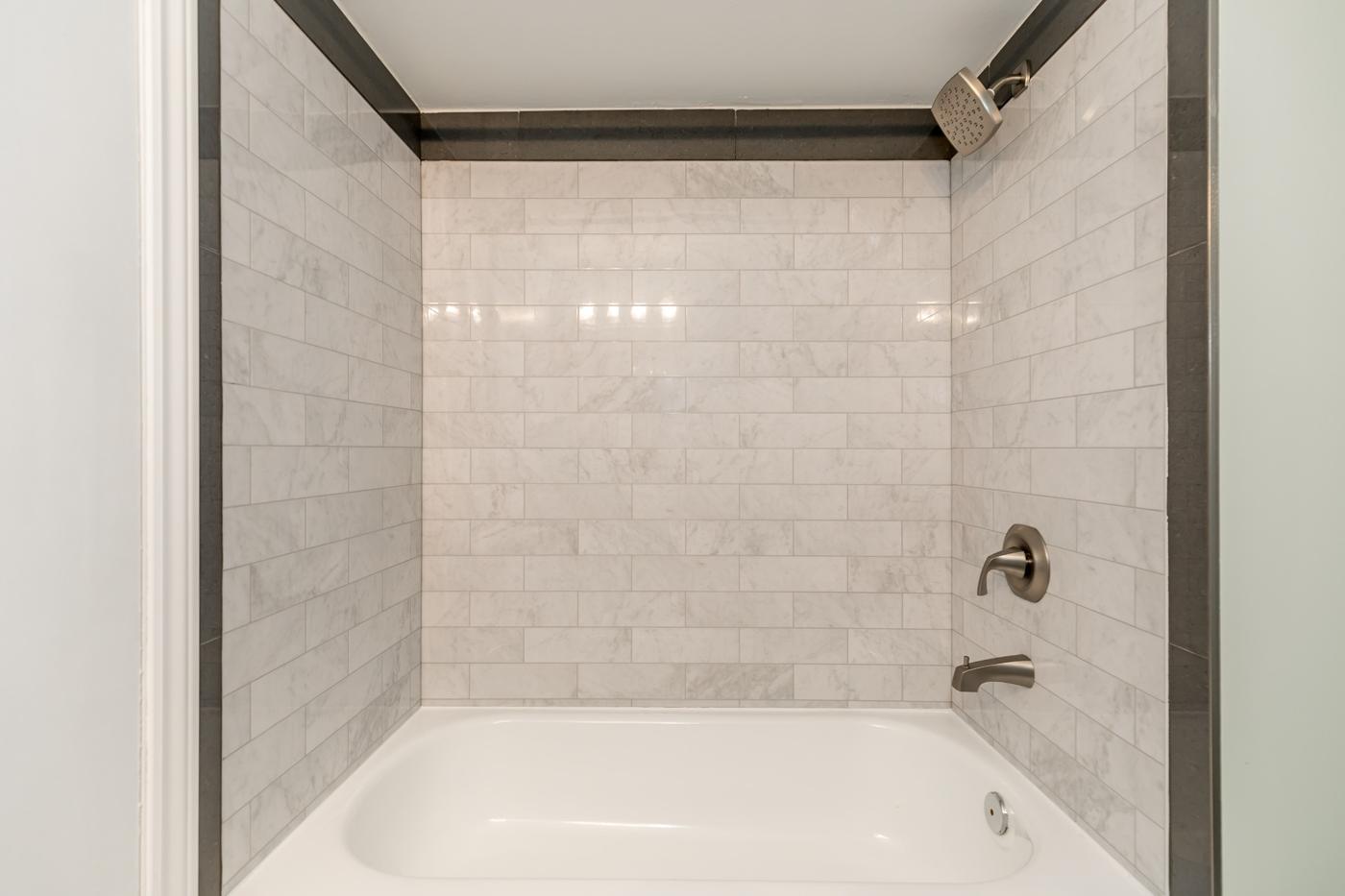 Completed Hilltop bathroom with a marble-look tub surround
