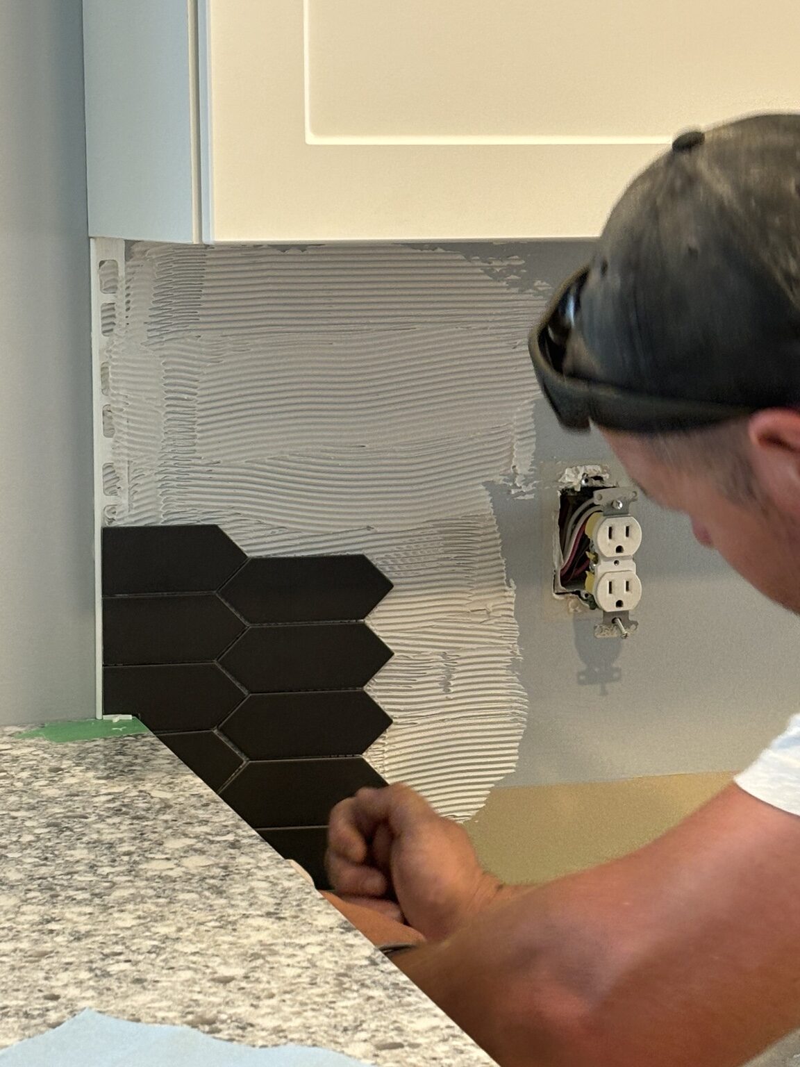Backsplash tile being installed in the Hyde Park kitchen