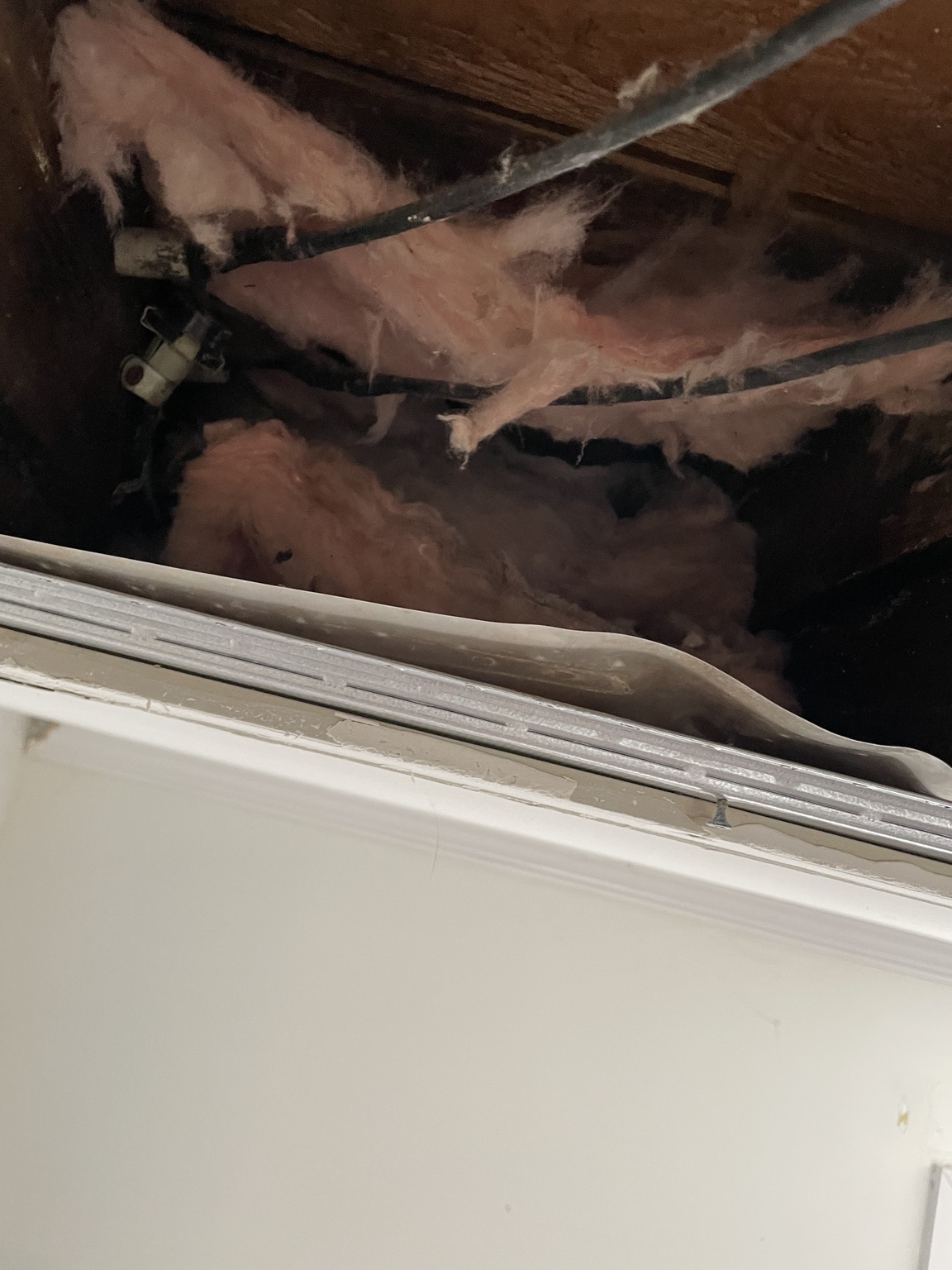 Ceiling insulation exposed during repair work