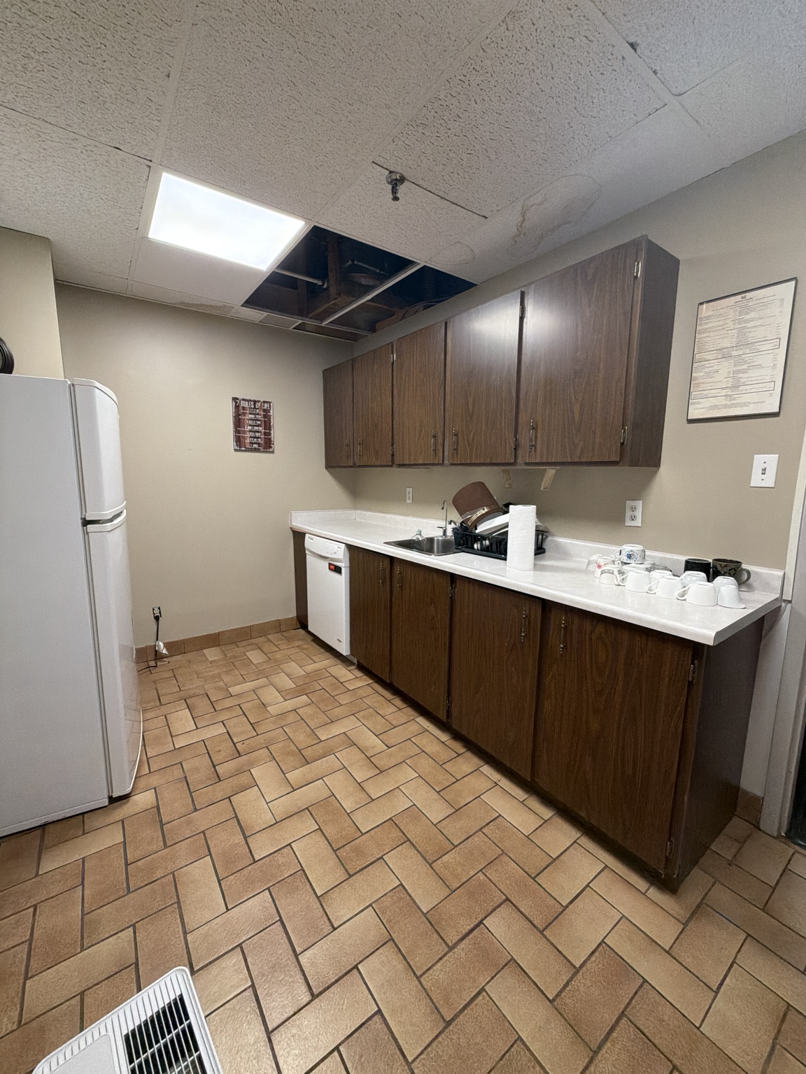 Older kitchenette before cabinetry and repair work