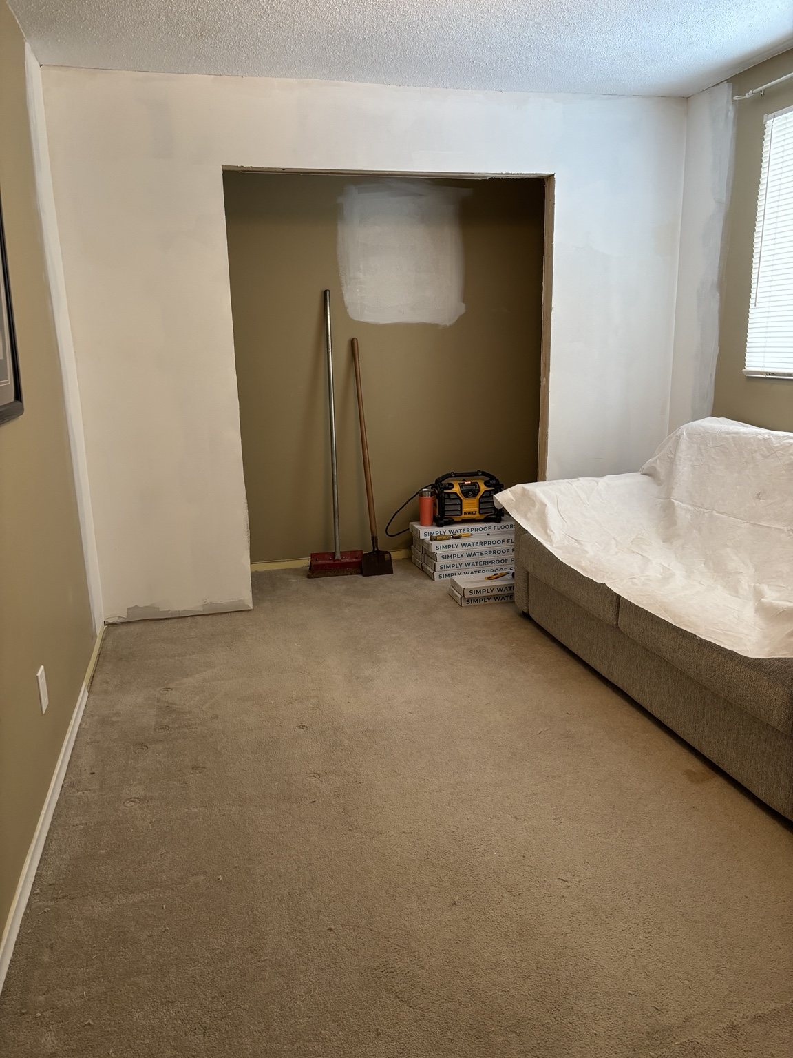 Medway room before flooring, with carpet and closet work already underway