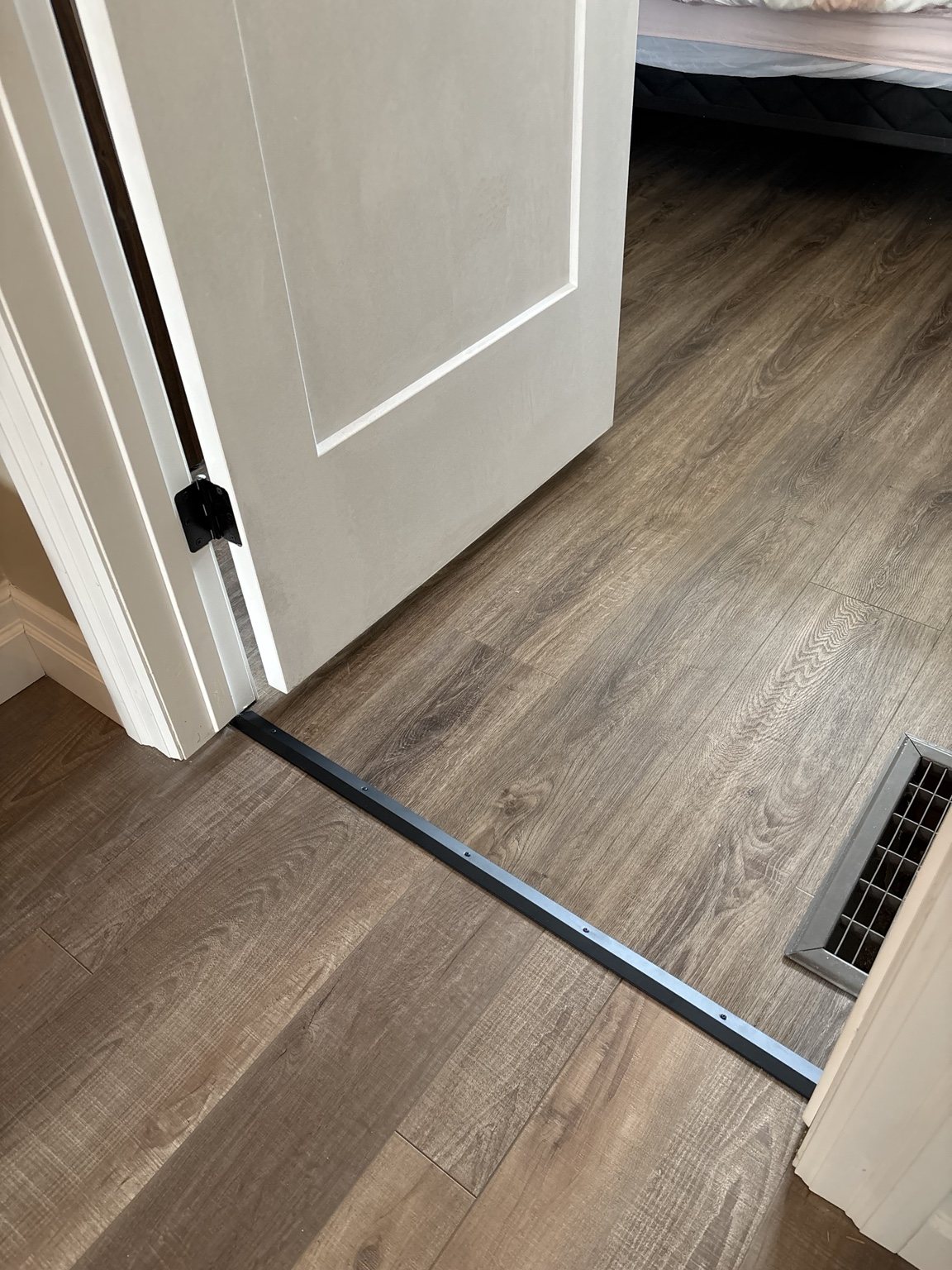 Completed Medway door, cool gray-brown plank flooring and clean threshold transition