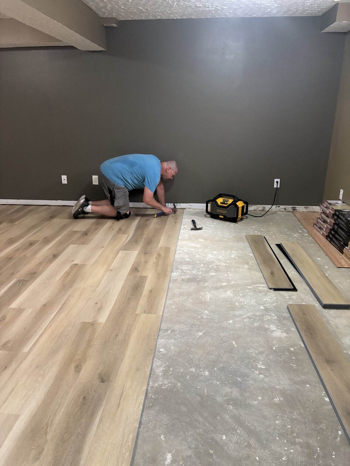 Light plank flooring being installed in the Pond Mills lower level