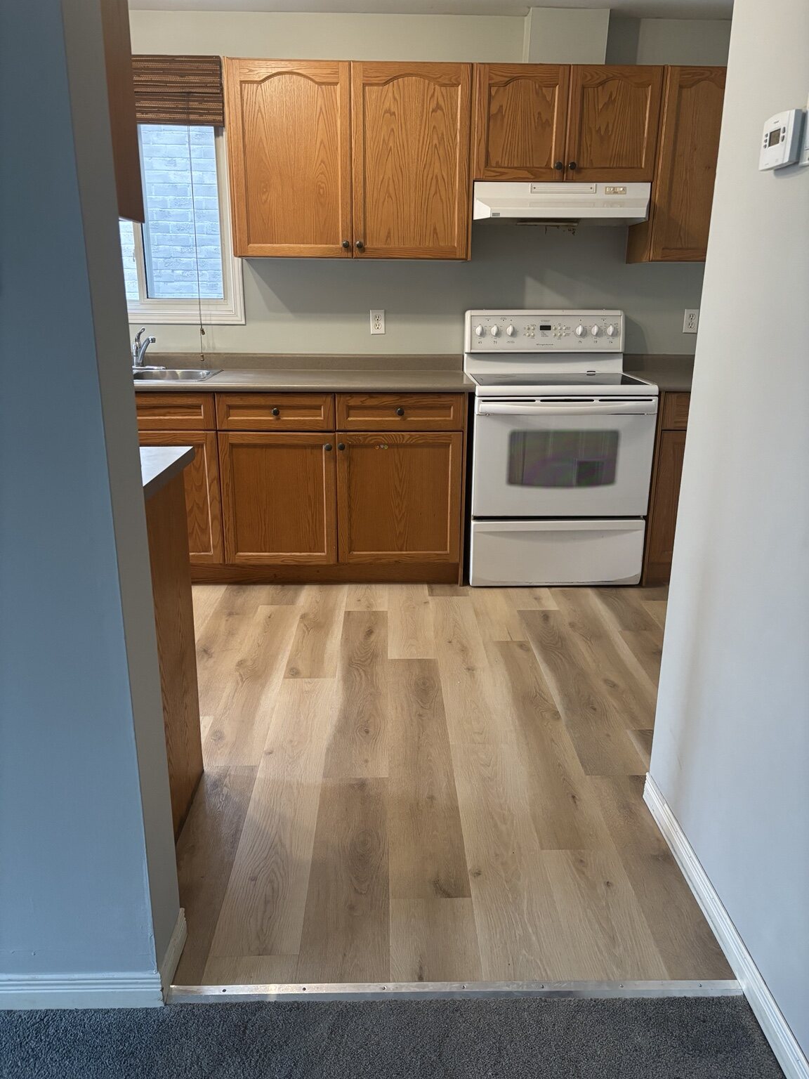 Same Pond Mills kitchen with completed light plank flooring