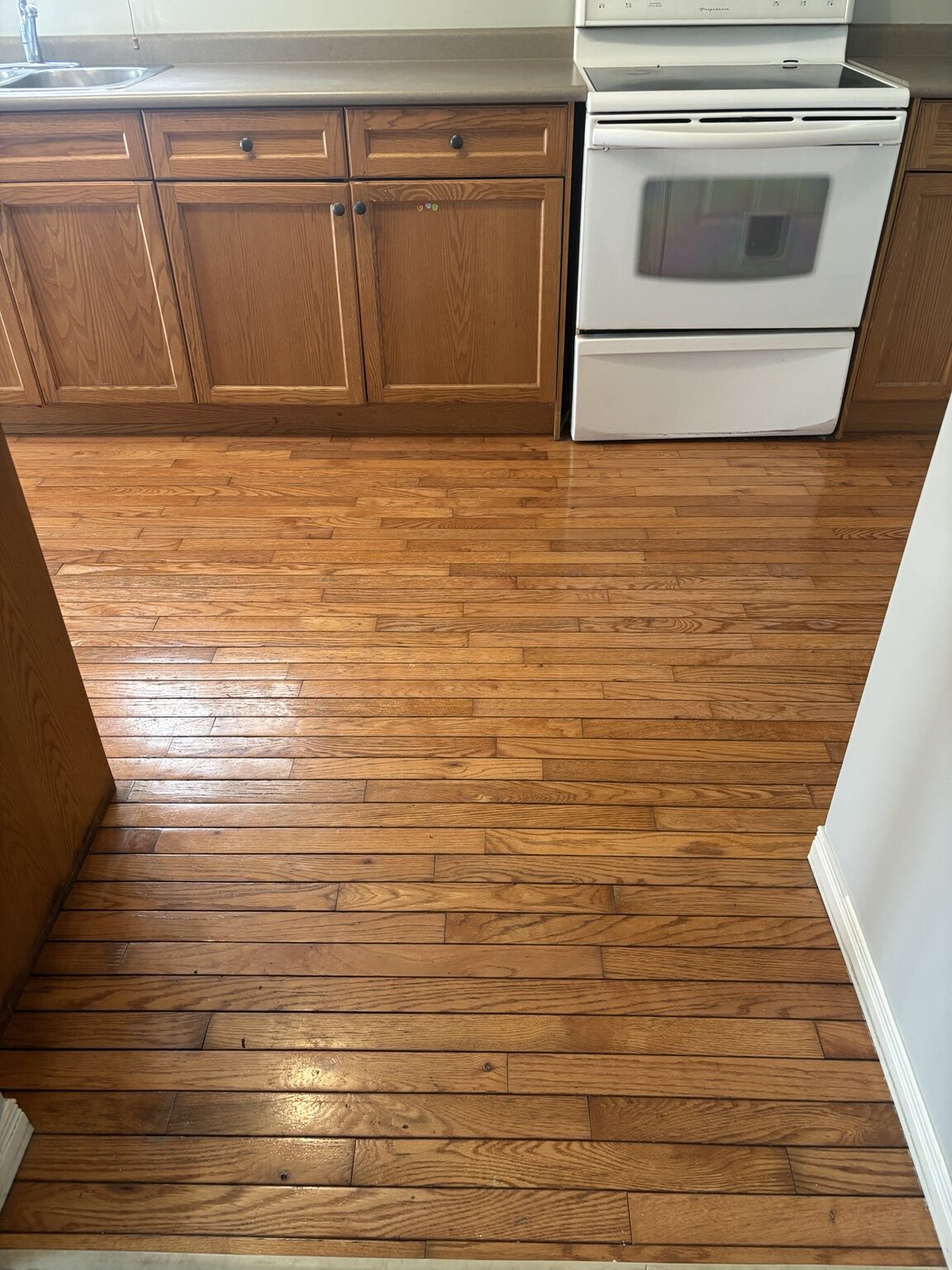 Pond Mills kitchen with the original narrow warm-toned flooring before work