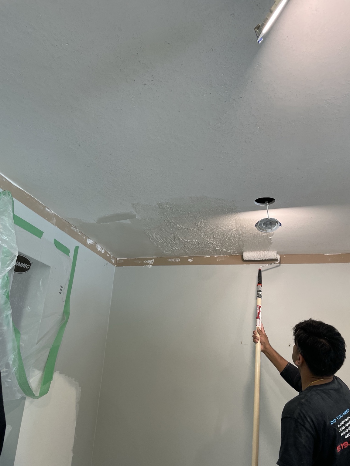 Primer being rolled onto a smoothed ceiling