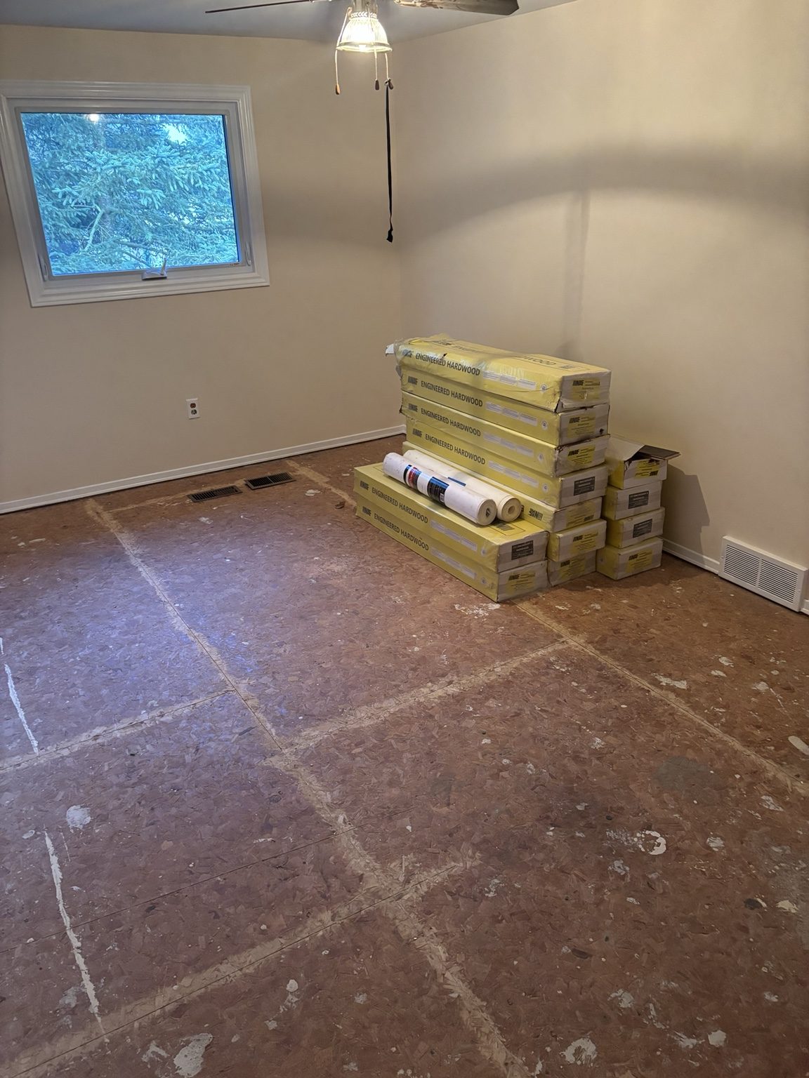 Prepared subfloor with engineered hardwood materials on site