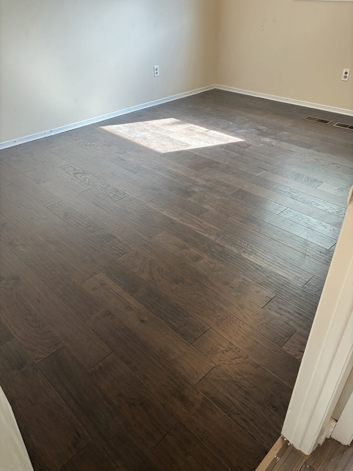 Dark wood flooring in a completed room
