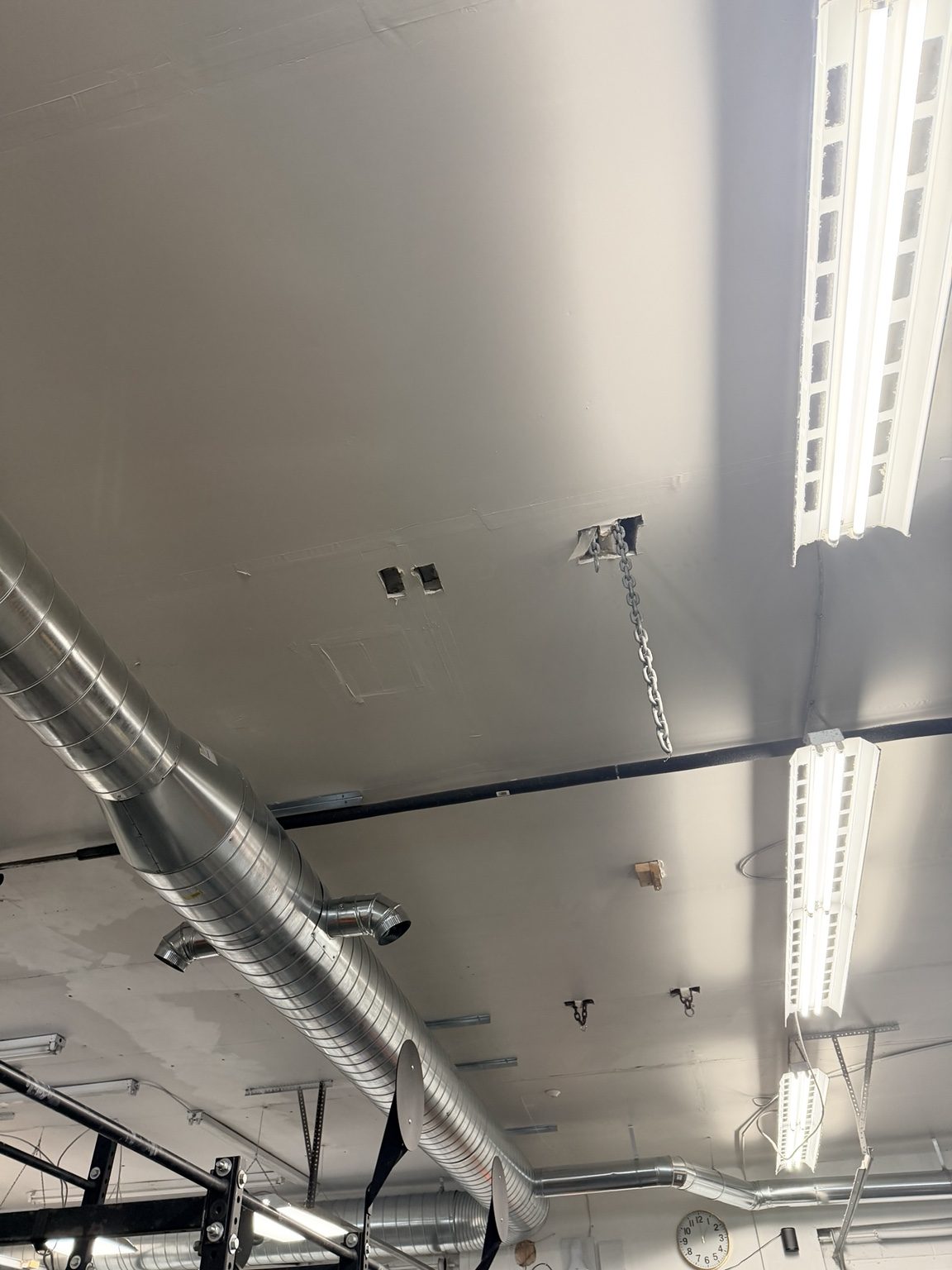 Older box-style fluorescent fixtures before the fitness-space lighting upgrade