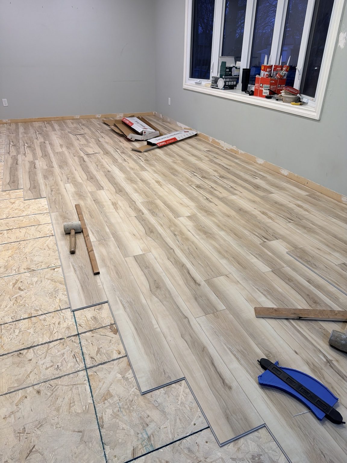 Click flooring installation beside a finished wall