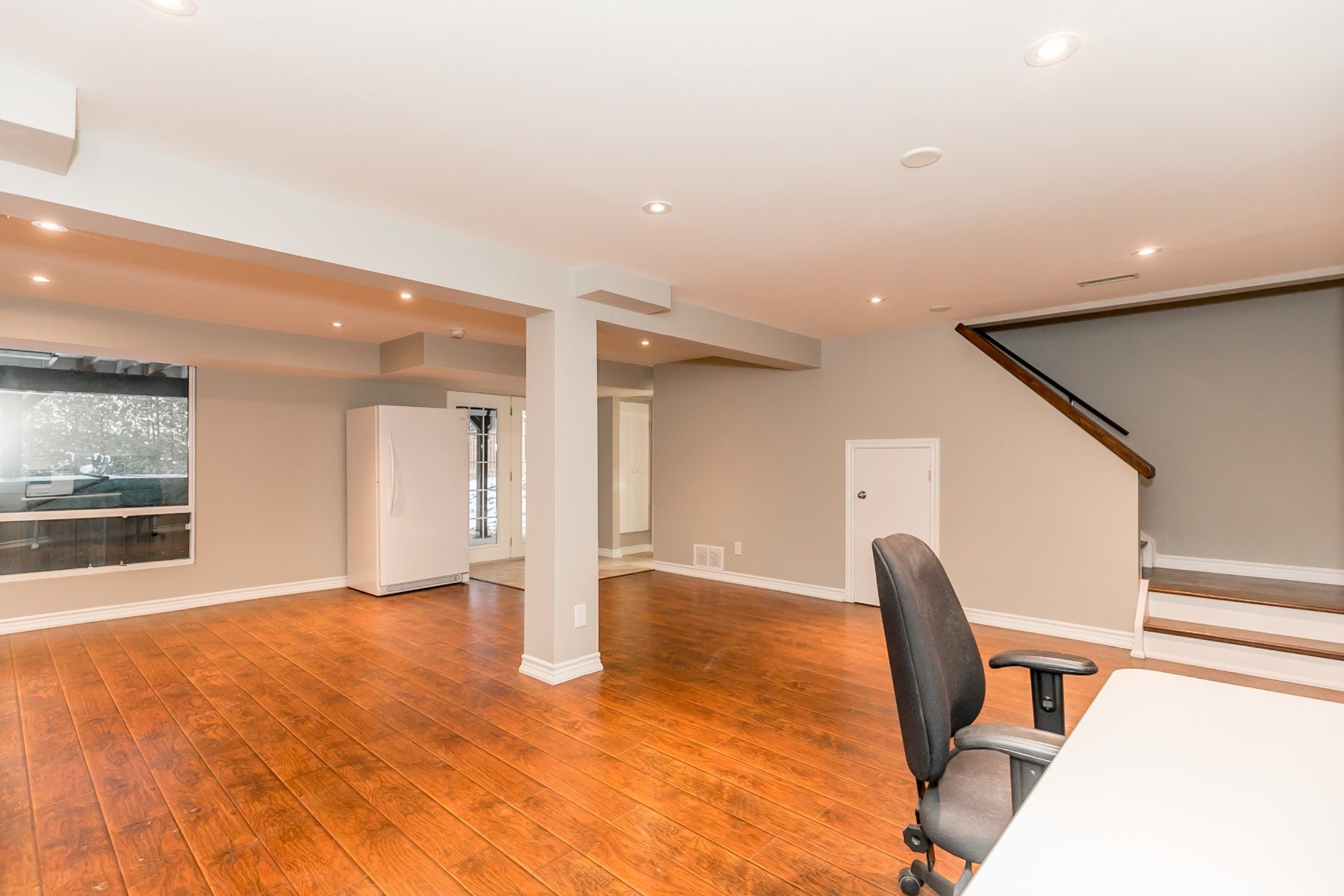 Completed lower-level room with ceiling lighting