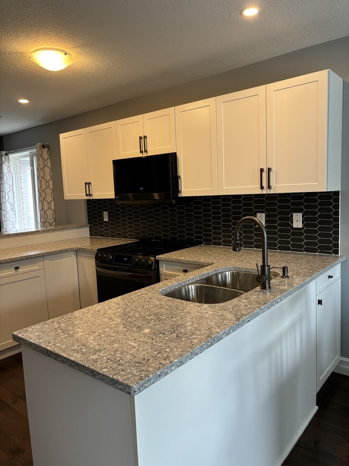 Completed kitchen renovation with bright cabinetry