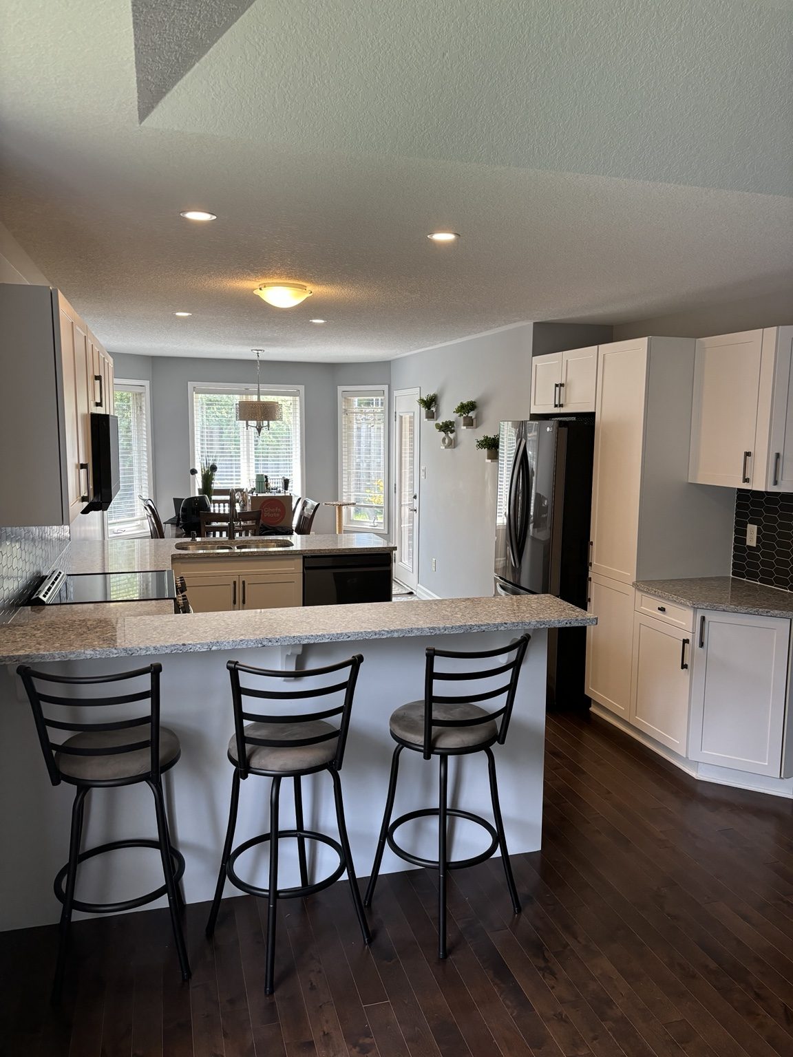 Completed Hyde Park kitchen viewed across the peninsula toward the pantry and dining area