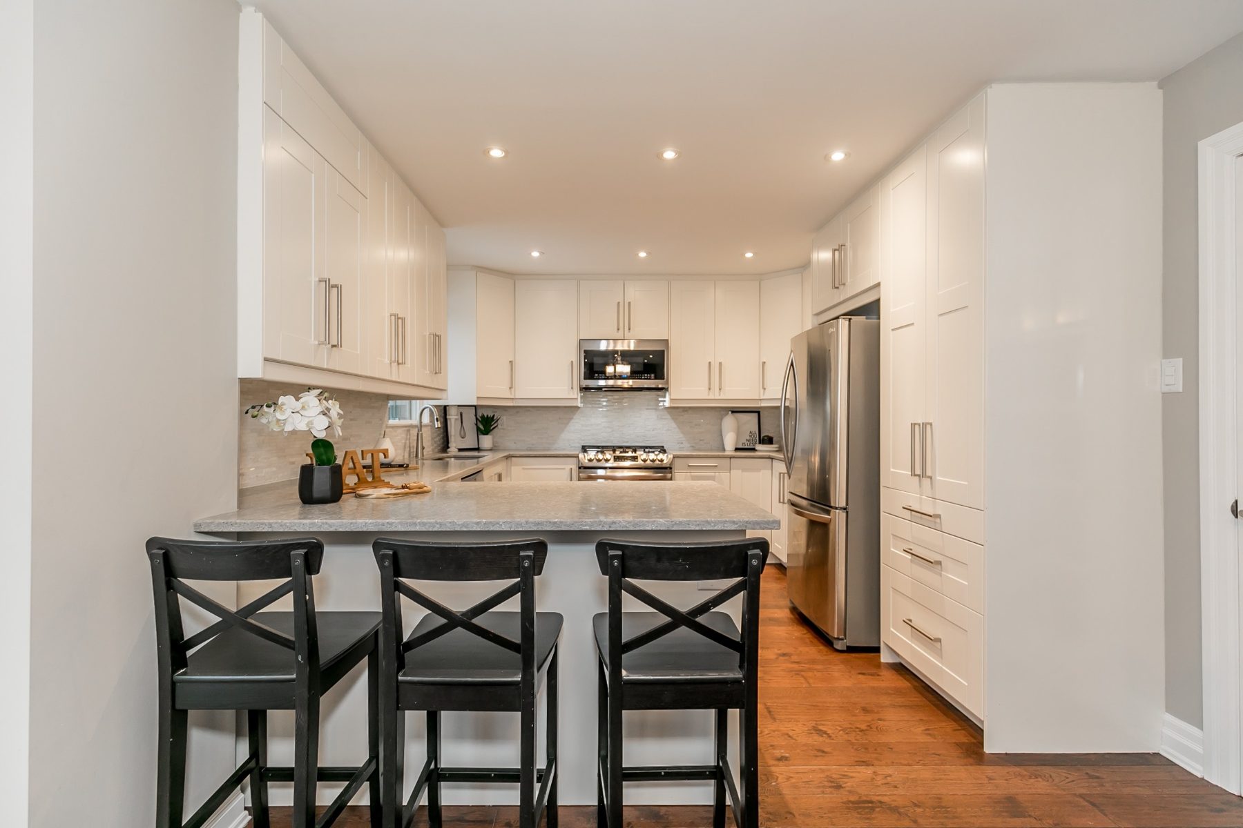 Completed white kitchen with island seating