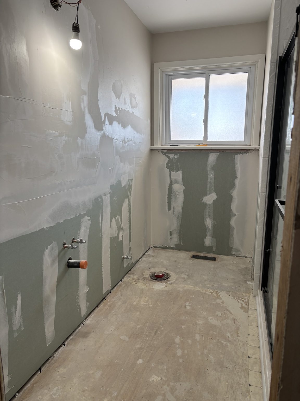 Wall-board rebuilding around a frosted bathroom window