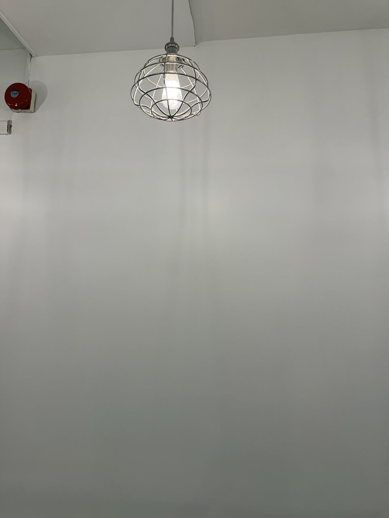 Completed repaired salon wall with its original alarm and ceiling details retained