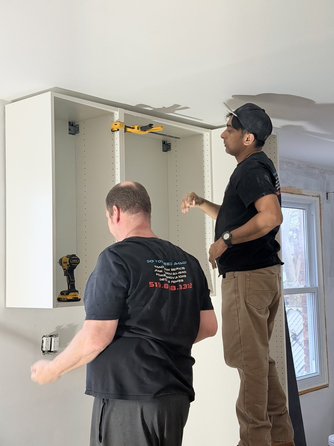 Hekman Home Services crew installing kitchen cabinetry in the phased Westmount project