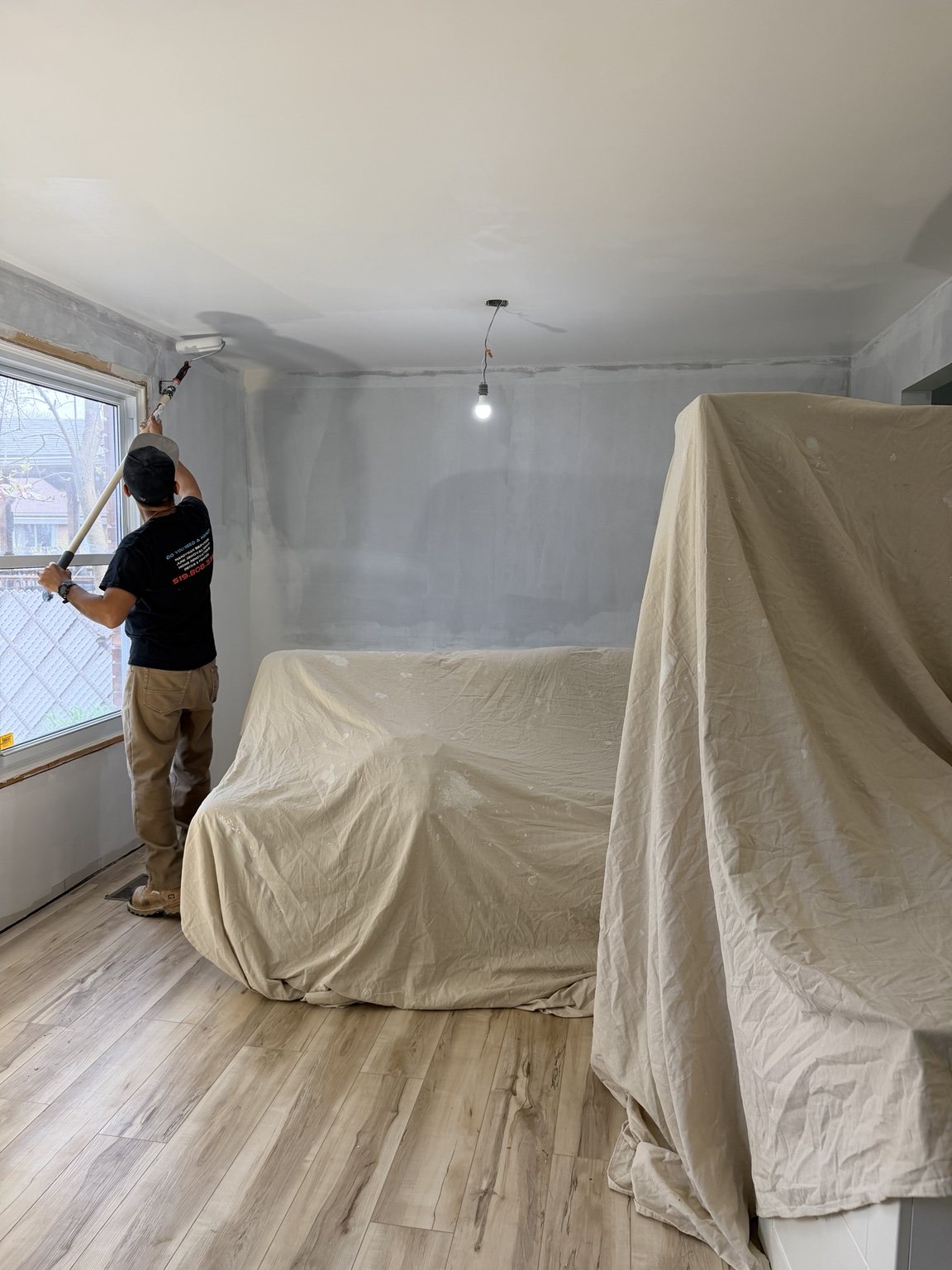 Westmount room protected with coverings while painting is underway